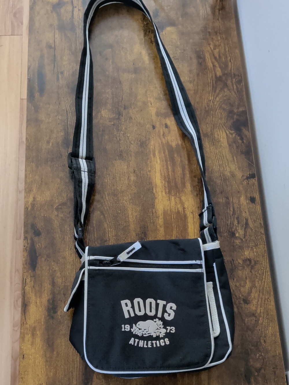 Roots Black and White Crossbody Bag with Striped Strap
